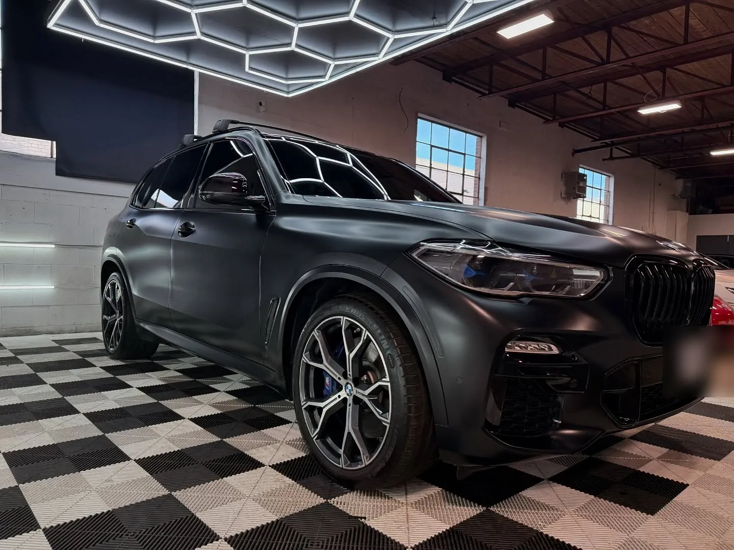 BMW X5 in full-body matte black colour PPF in the studio